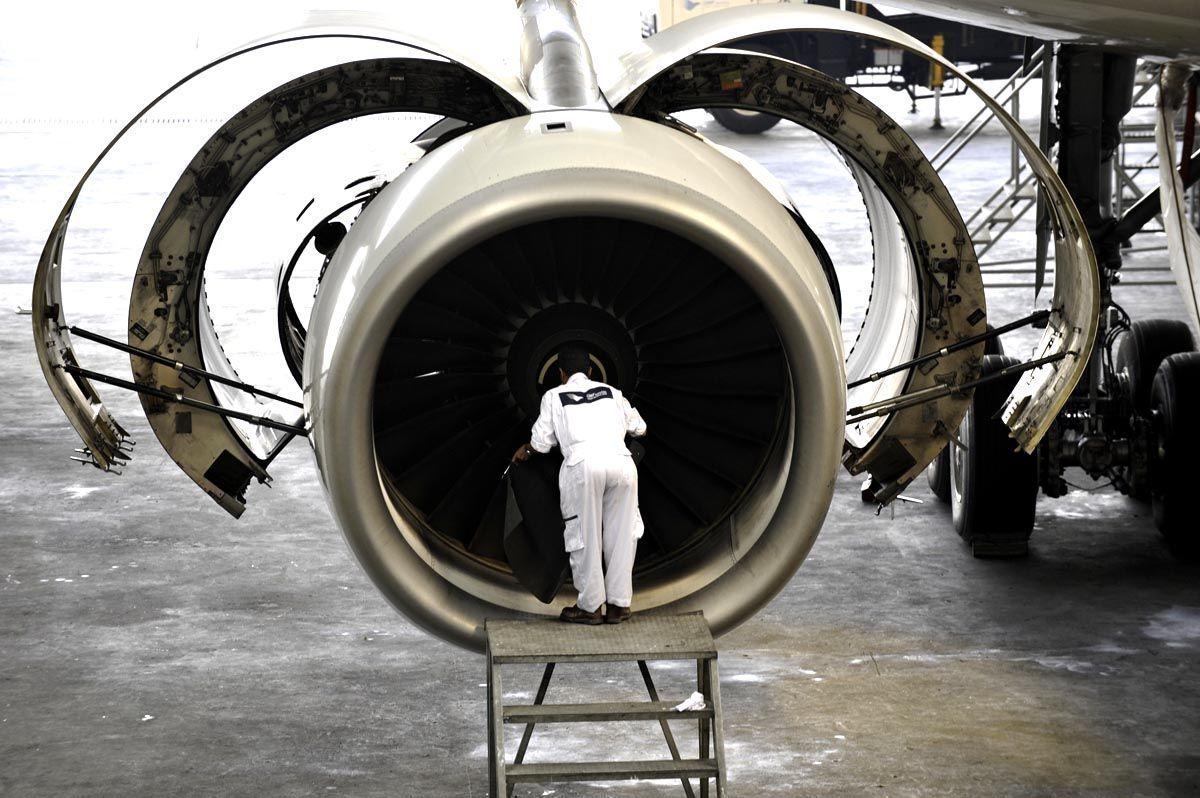 A technician checks the Rolls Royce engine of an Airbus A330 aircraft.