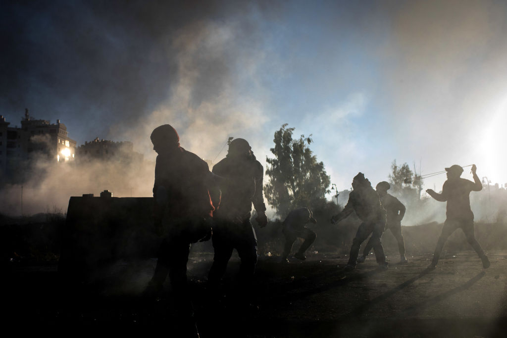 Palestinian protesters hurl rocks at Israeli border guards during clashes near an Israeli checkpoint on December 8 2017 in Ramallah West Bank 
Photo by Chris McGrath/Getty Images