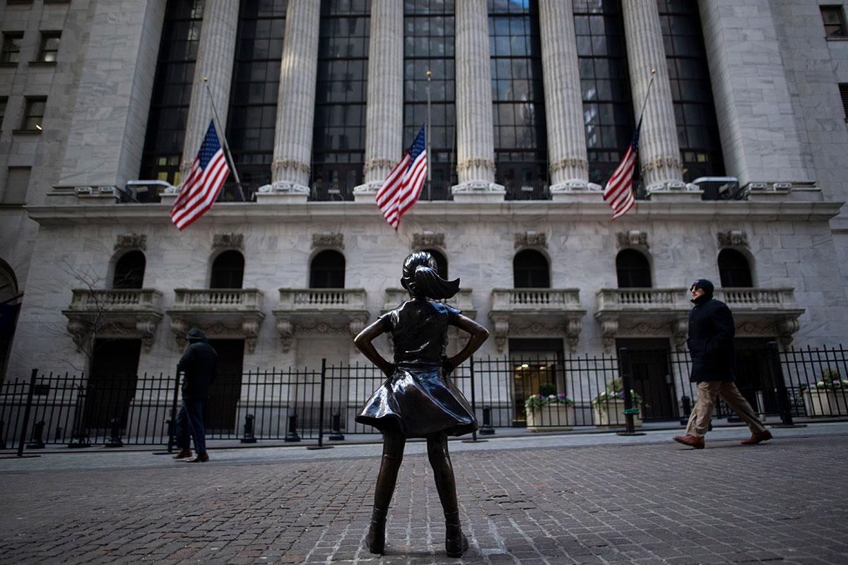 The 'Fearless Girl' statue stands facing the New York Stock Exchange.