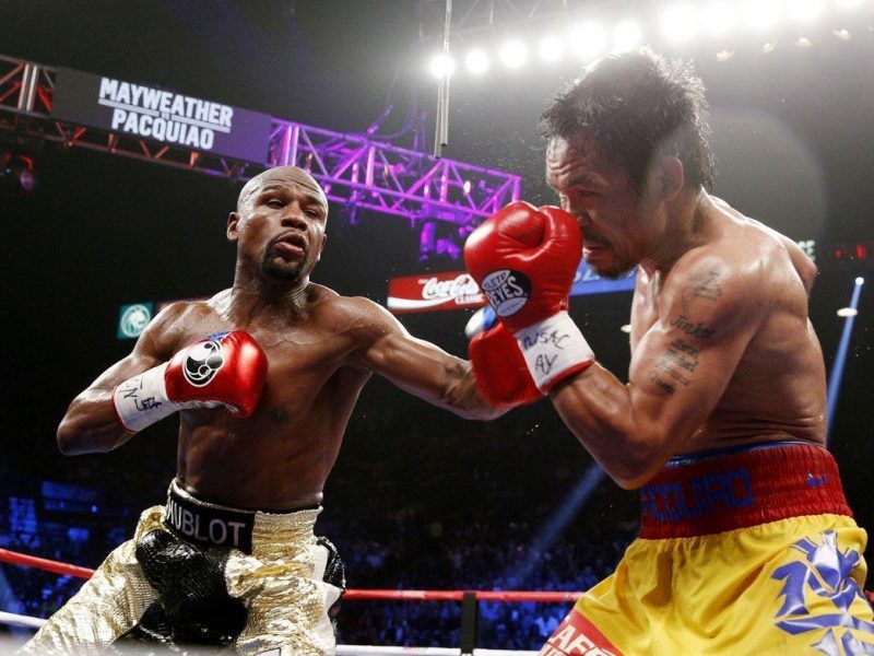 Floyd Mayweather Jr. exchange punches with Manny Pacquiao during their welterweight unification championship bout, May 2, 2015 at MGM Grand Garden Arena in Las Vegas, Nevada. (Getty Images)