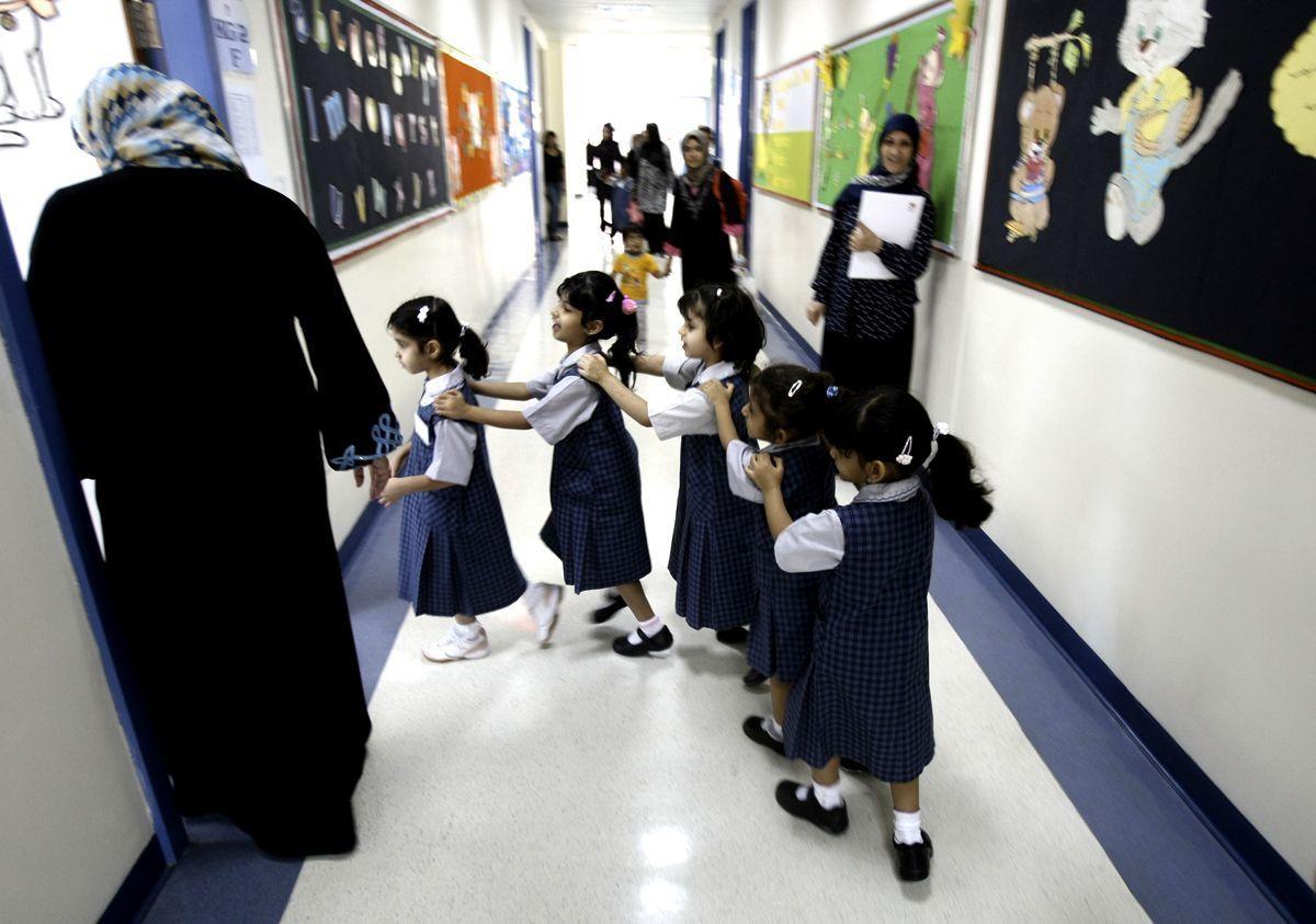 Students line-up as they ente their classroom on the first day of the academic year for public schools in Dubai on September 27, 2009. Many students were still absent as parents remain reluctant to send their children to school from fear of swine flu. (Karim Sahib/AFP/Getty Images)