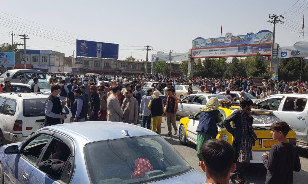 Afghans crowd on the tarmac of Kabul's international airport on Monday. Image: Bloomberg