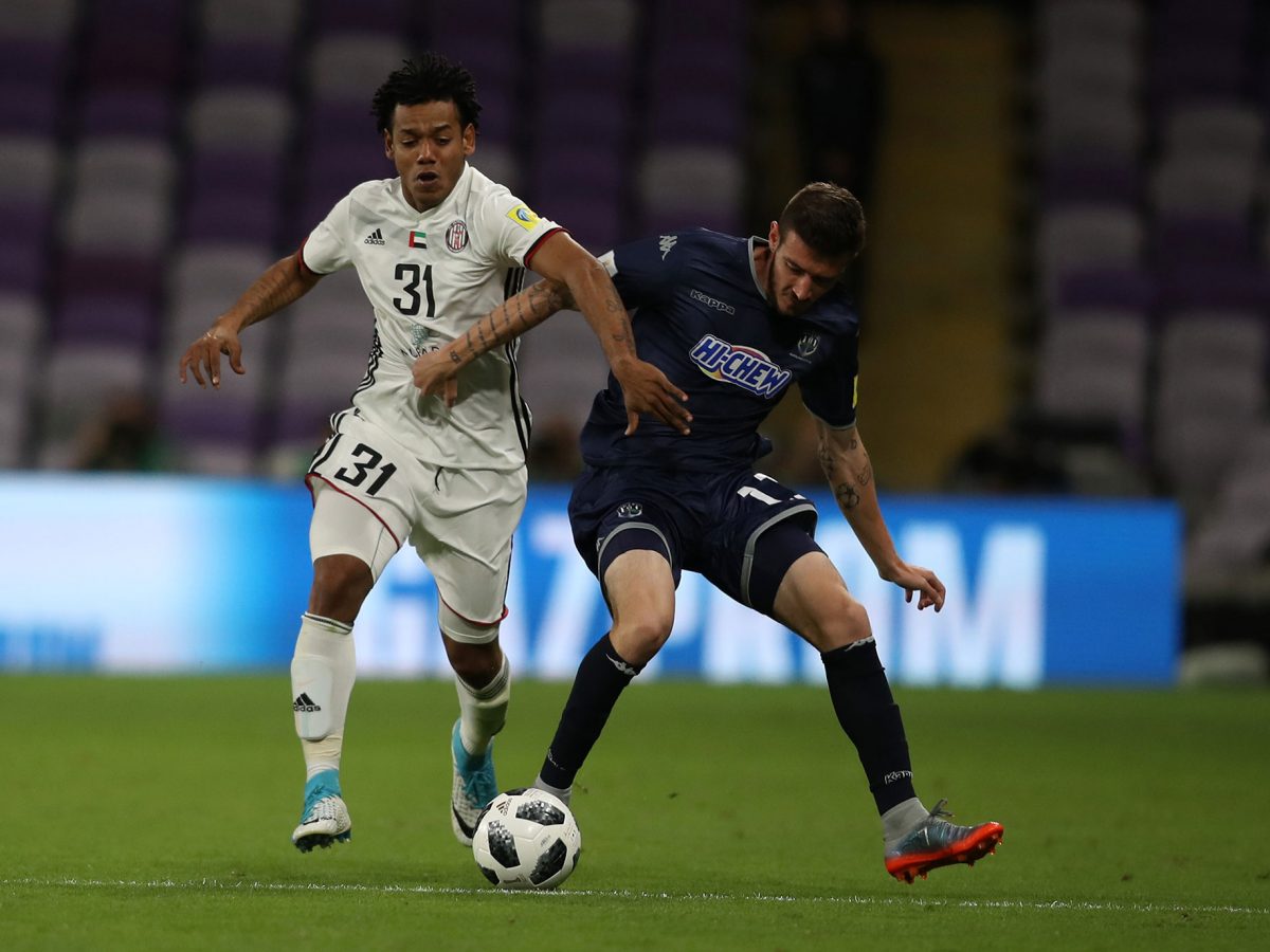 Romarinho of Al-Jazira is challenged by Fabrizio Tavano of Auckland City FC during the FIFA Club World Cup UAE 2017 play off match between Al Jazira and Auckland City FC at the Hazza Bin Zayed Stadium in Al Ain.