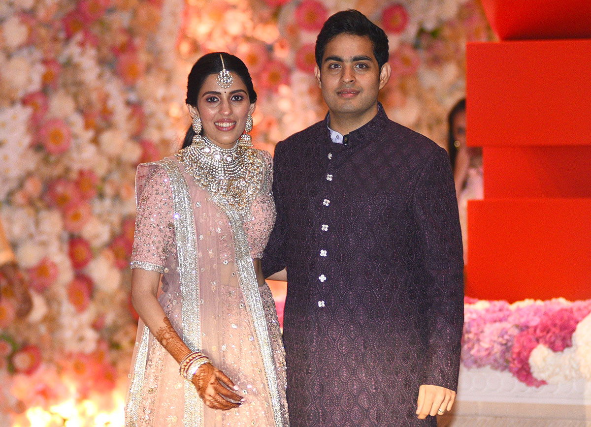 Akash Ambani (R), the eldest son of India's richest man and Reliance Industries Limited Chairman, Mukesh Ambani, and fiancee Shloka Mehta pose at their pre-engagement party in Mumbai.