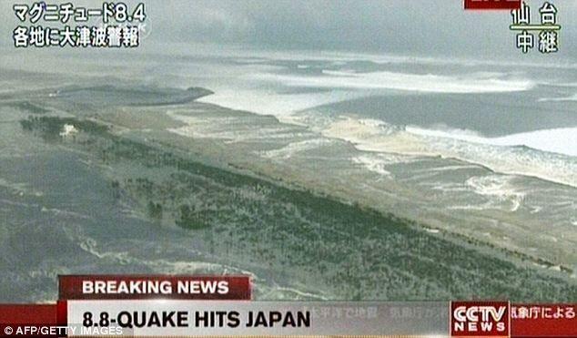 A tsunami hits Japan following a massive earthquake. (Getty Images)