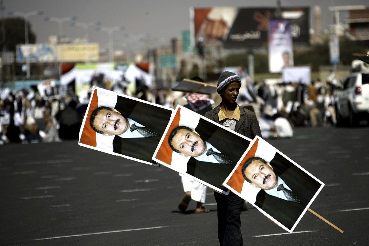 A Yemeni supporter of President Ali Abdullah Saleh holds his portraits during a pro-regime rally after the weekly Friday prayers in Sanaa on December 2 2011. (MOHAMMED HUWAIS/AFP/Getty Images)