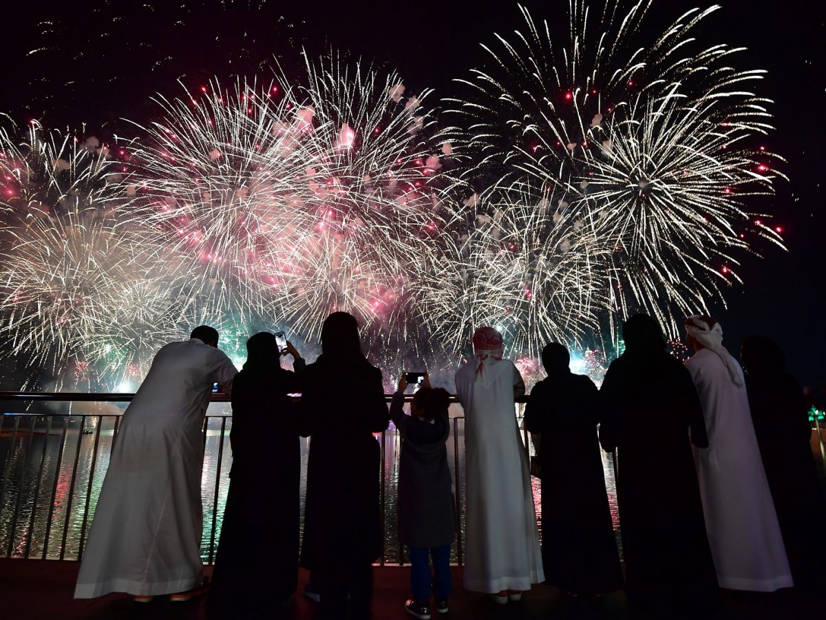 People watch fireworks exploding in front of the Atlantis Hotel at The Palm Jumeirah in Dubai. (GIUSEPPE CACACE/AFP/Getty Images)