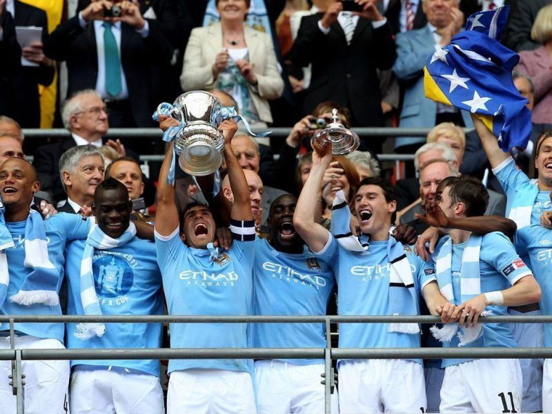 Carlos Tevez lifts the trophy after he and his Manchester City team mates won the FA Cup sponsored by E.ON Final match between Manchester City and Stoke City at Wembley Stadium on May 14, 2011 in London, England. (Getty Images)