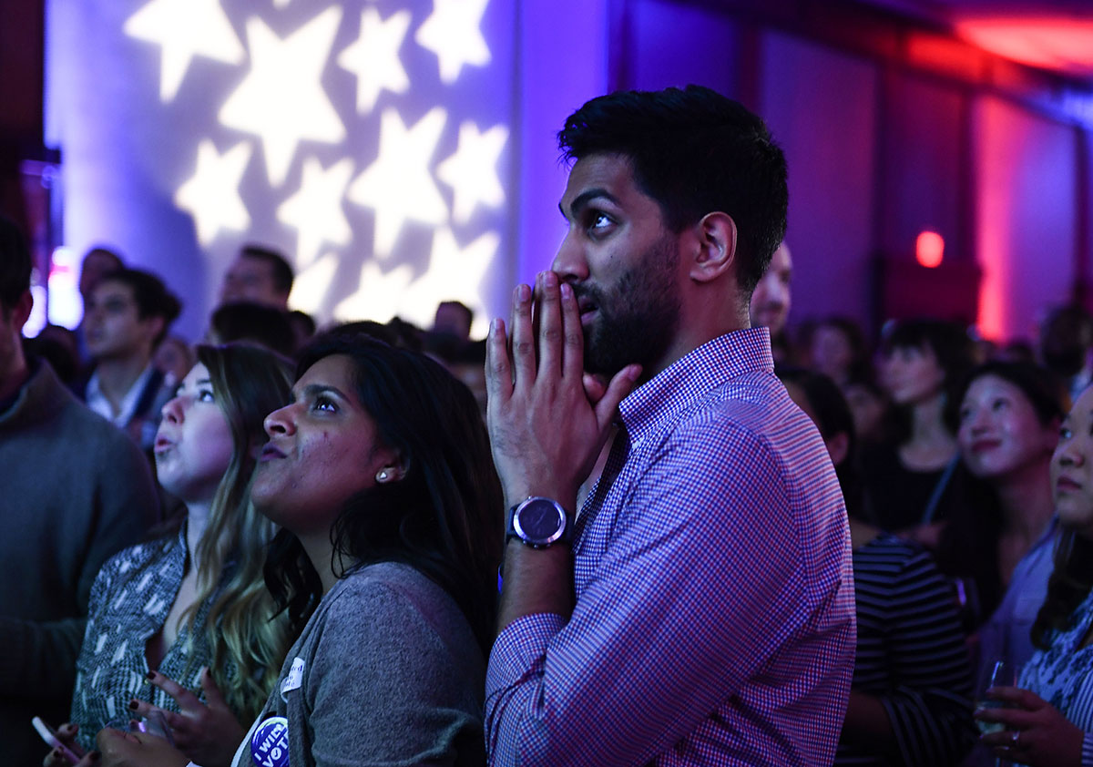 People react to live results while attending a midterm election night party hosted by the Democratic Congressional Campaign Committee November 6, 2018 in Washington, DC.