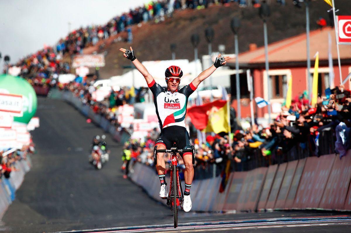 Slovenias Jan Polanc of team UAE Emirates celebrates as he crosses the finish line to win the 4th stage of the 100th Giro dItalia, Tour of Italy, cycling race from Cefalu to Etna volcano in Sicily. (LUK BENIES/AFP/Getty Images)