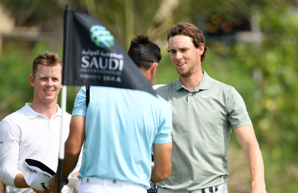 Thomas Pieters of Belgium, right, on the 9th green during the first round of the Saudi International at the Royal Greens Golf  Country Club. (Ross Kinnaird/Getty Images)