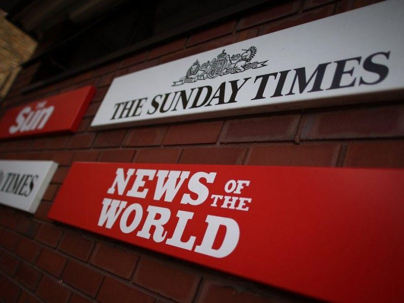 Signs for the four newspapers belonging to News International dominate the entrance at the Wapping production plant in London, England. (Getty Images)