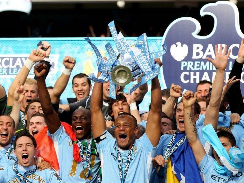 Vincent Kompany, the captain of Manchester City, lifts the trophy following the Barclays Premier League match between Manchester City and Queens Park Rangers at the Etihad Stadium. (Getty Images)