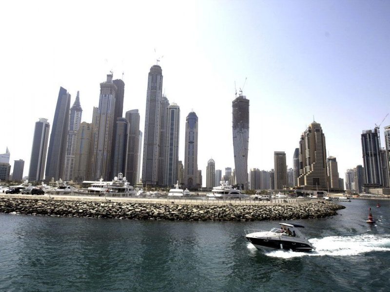 A speed boat exits the new Dubai Marina with its high rise apartment towers in Dubai. (AFP/Getty Images)