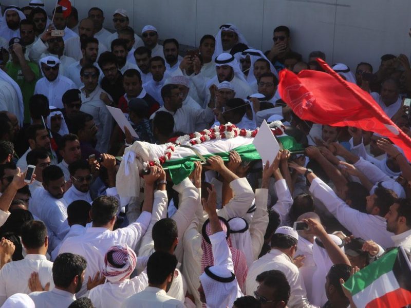 Mourners carry the body of one of the victims of the Al-Imam Al-Sadeq mosque bombing, during a mass funeral at Jaafari cemetery in Kuwait City. (AFP/Getty Images)