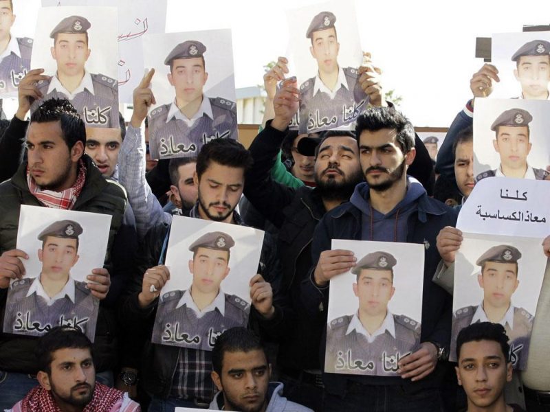 Activists carry posters with a portrait of the Jordanian pilot Maaz al-Kassasbeh, who was killed by ISIL. (AFP/Getty Images)