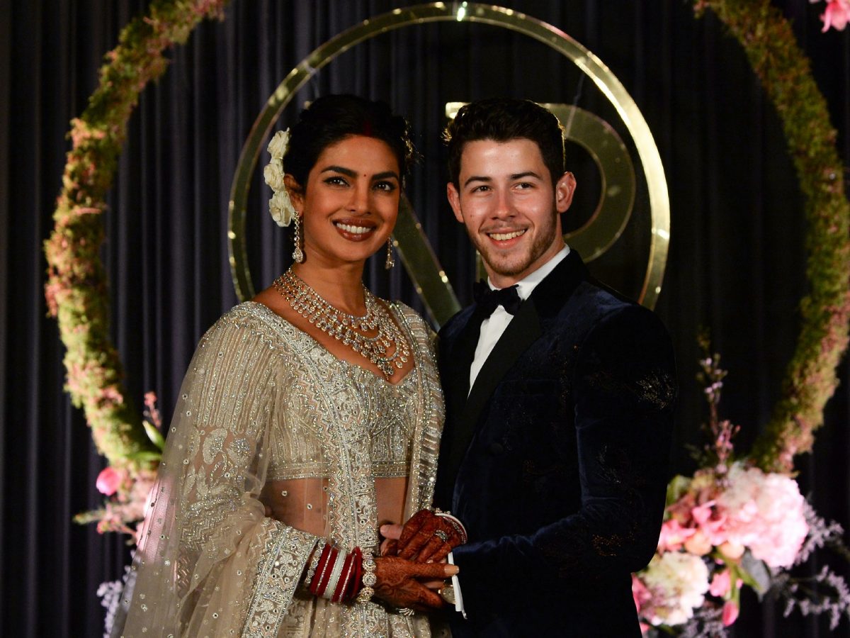 Indian Bollywood actress Priyanka Chopra and US musician Nick Jonas who were recently married pose for a photograph during a reception in New Delhi 
Photo: SAJJAD HUSSAIN/AFP/Getty Images