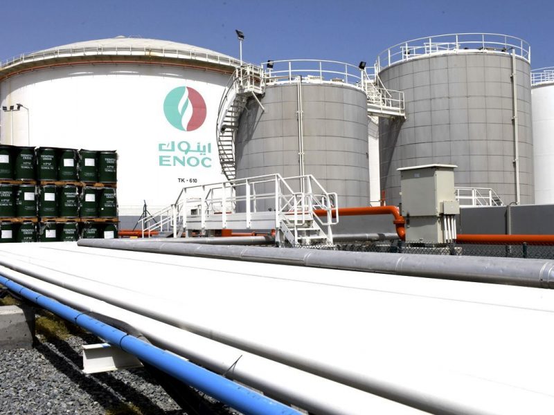 An ENOC-branded oil storage tank stands near pipe work at the Emirates National Oil Co. lubricants and grease manufacturing plant in Fujairah, United Arab Emirates, on Monday, March 12, 2012. ENOC, as Dubais government-owned refiner is known, will expand the plants capacity to 250,000 tons a year by 2014, it said. (Bloomberg)