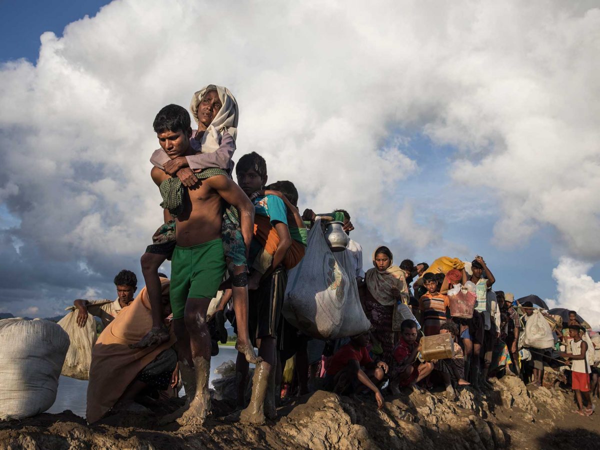 Thousands of Rohingya refugees fleeing from Myanmar walk along a muddy rice field after crossing the border in Palang Khali, Cox's Bazar, Bangladesh. (Getty Images)