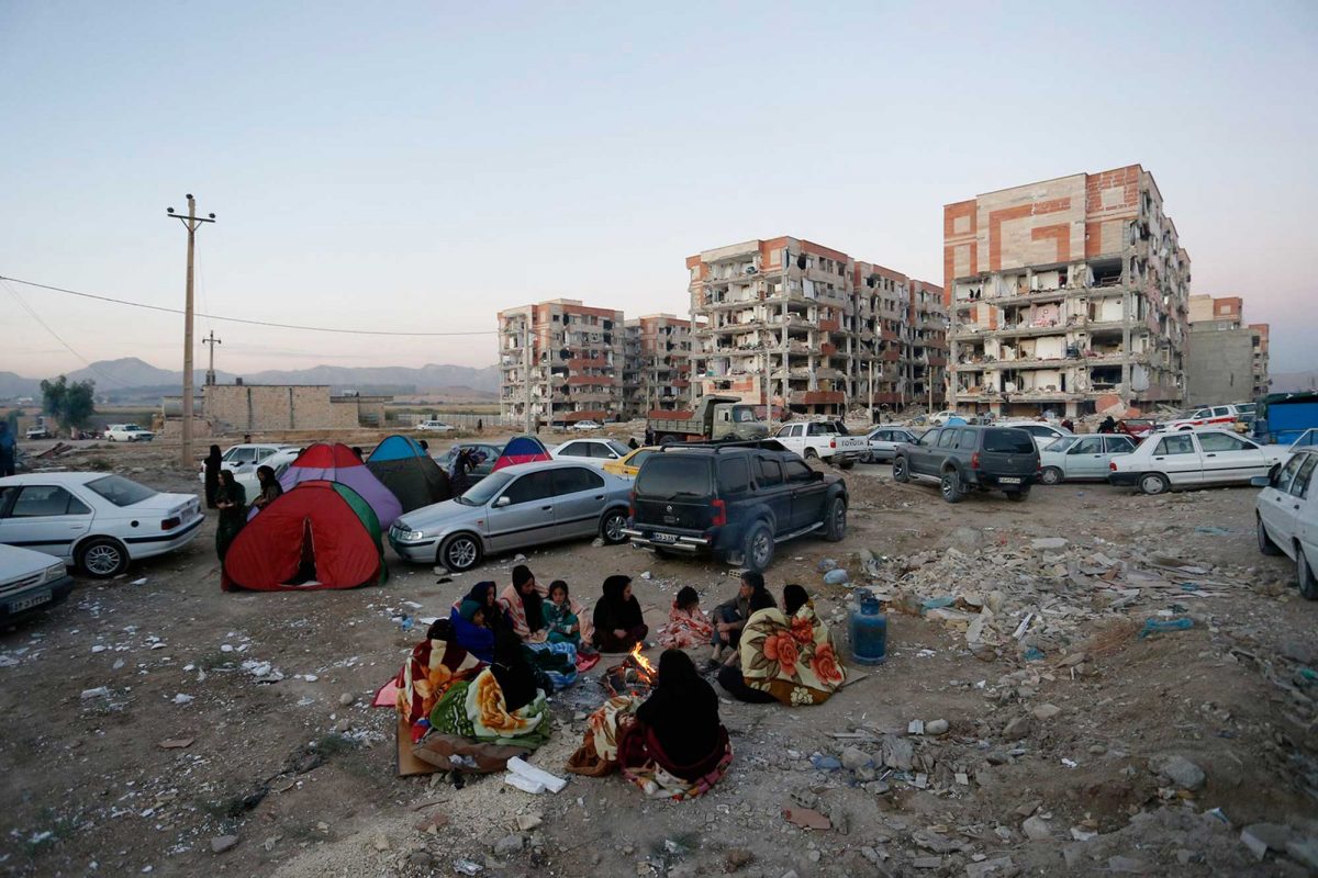 Residents huddle by a fire in an open area following a 7.3-magnitude earthquake at Sarpol-e Zahab in Iran's Kermanshah province.