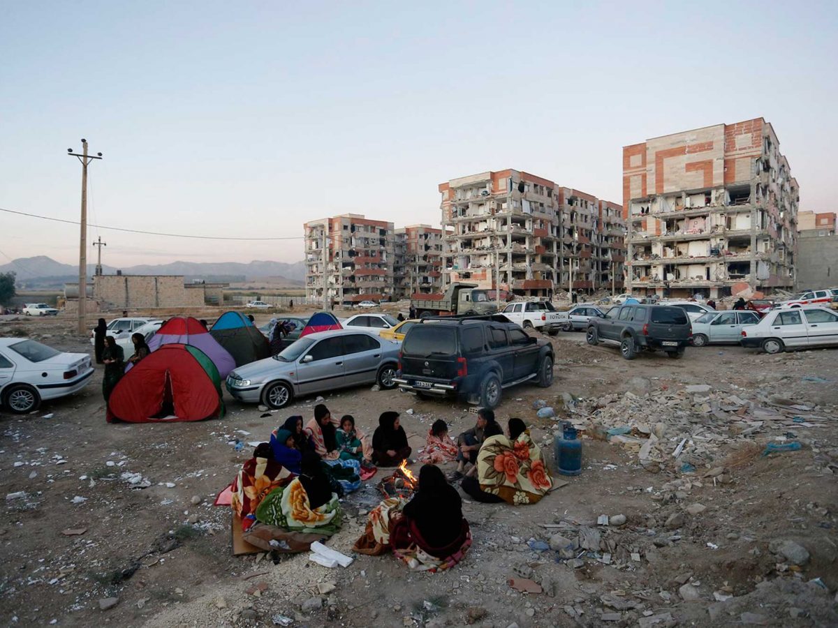 Residents huddle by a fire in an open area following a 7.3-magnitude earthquake at Sarpol-e Zahab in Iran's Kermanshah province.