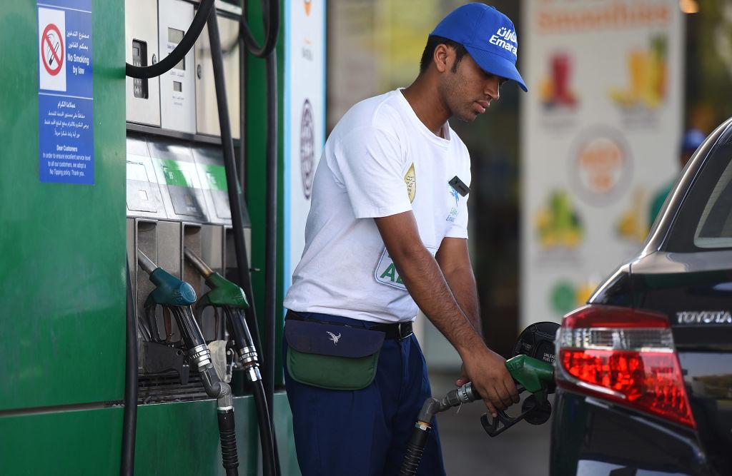 An Emarat petrol station attendant fills up the tank of a car in Dubai. (Tom Dulat/Getty Images)