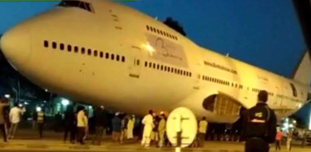 The wingless Boeing 747 aircraft being transported by trucks along the corniche.