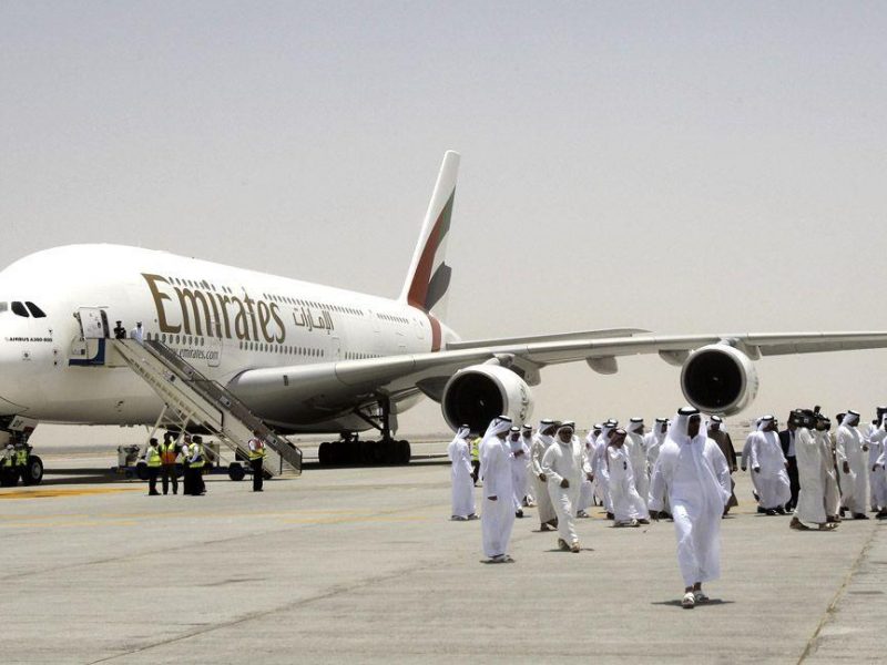 Members of the media and officials walk on the runway in front of an Emirates Airlines plane during the media tour of Dubais new second airport. (Getty Images)