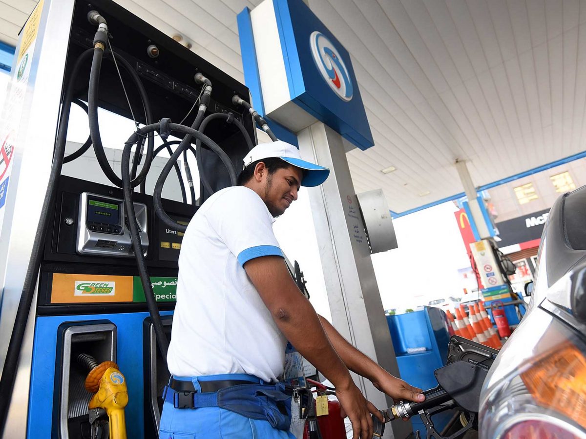 A petrol station attendant fills up the tank of a car in Dubai. (Getty Images)