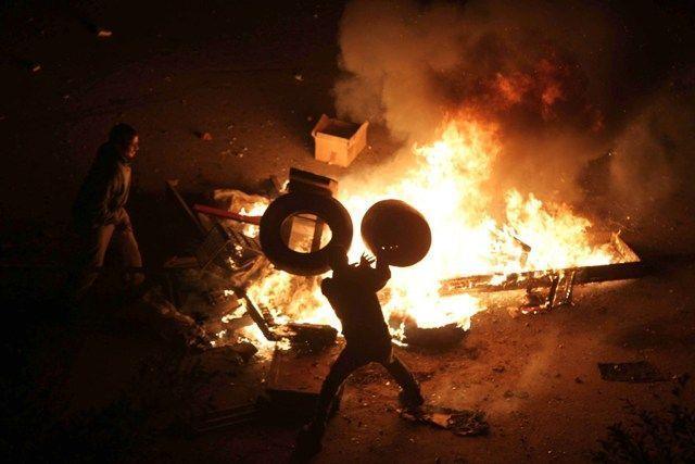 Egyptian demonstrators demanding the ouster of President Hosni Mubarak burn tires in Suez, east of the capital Cairo on January 27. On January 28, the protesters stamped on posters of the president in demonstrations after Friday prayers (Getty Images)