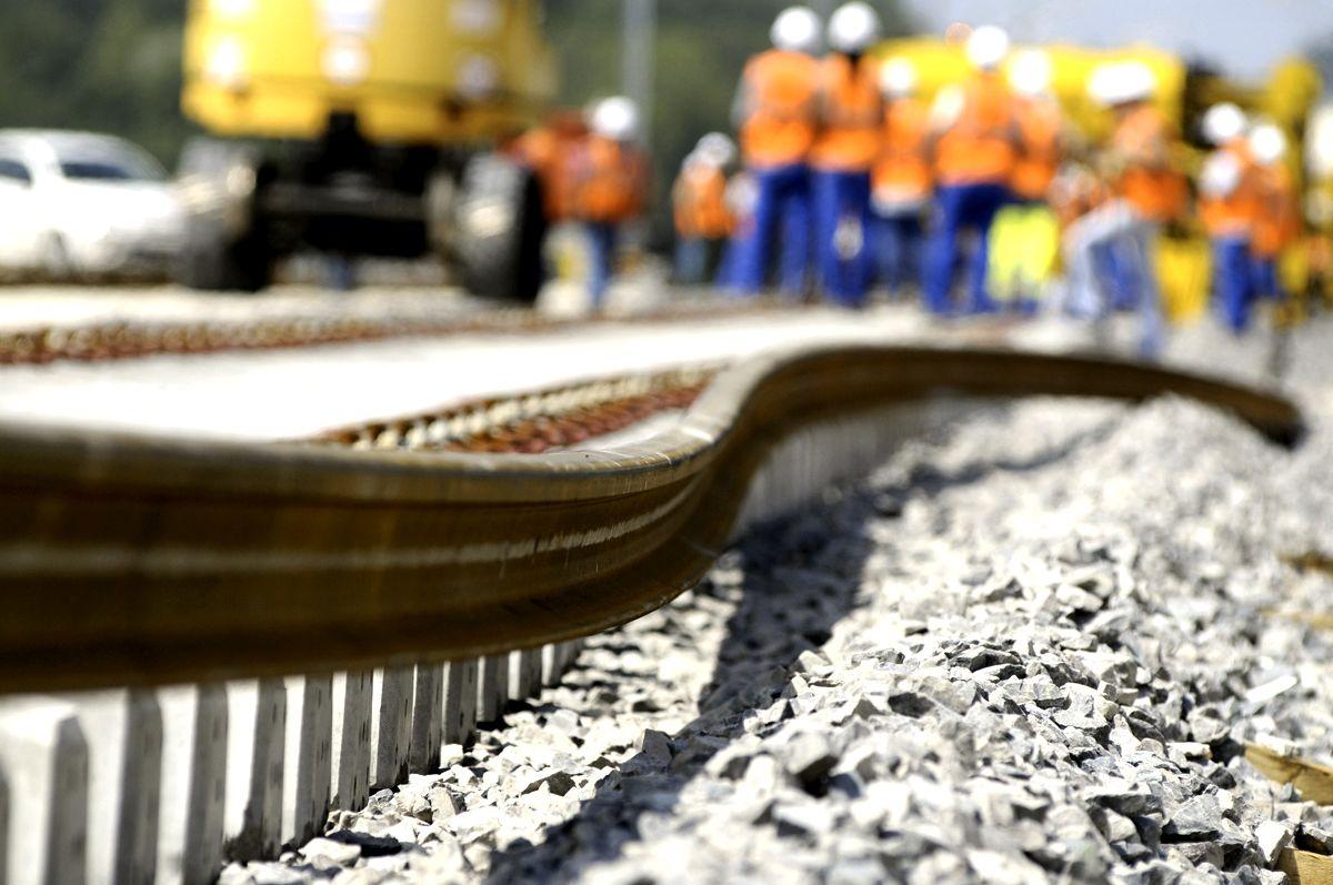 Workers install the first track of the new French high speed train (TGV) Lyon-Strasbourg line in Les Magny, eastern France, on June 29, 2009. The line will be opened in 2011. AFP PHOTO SEBASTIEN BOZON (Photo credit should read SEBASTIEN BOZON/AFP/Getty Images)