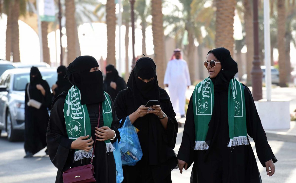 Saudi families arrive outside a stadium to attend an event in the capital Riyadh on September 23, 2017 commemorating the anniversary of the founding of the kingdom. The national day celebration coincides with a crucial time for Saudi Arabia, which is in a battle for regional influence with arch-rival Iran, bogged down in a controversial mi