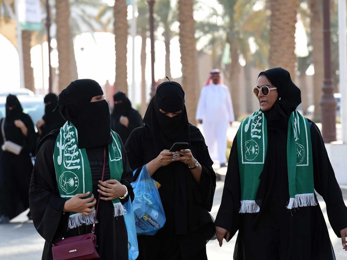 Saudi families arrive outside a stadium to attend an event in the capital Riyadh on September 23, 2017 commemorating the anniversary of the founding of the kingdom. The national day celebration coincides with a crucial time for Saudi Arabia, which is in a battle for regional influence with arch-rival Iran, bogged down in a controversial mi