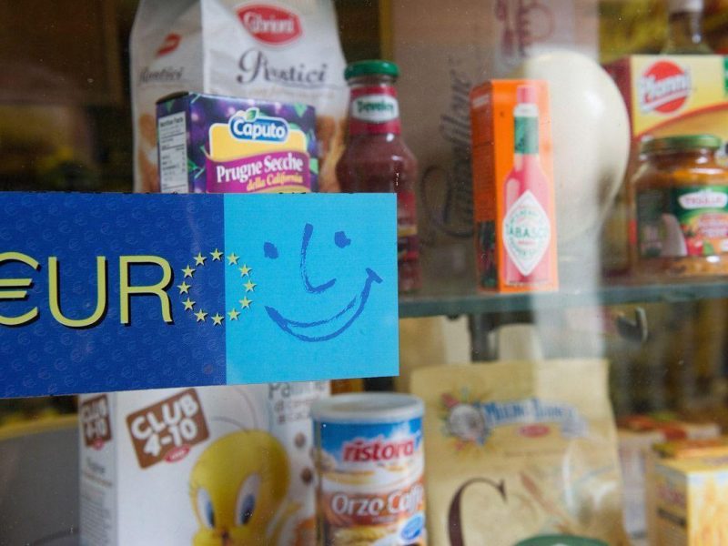 An old sign welcoming the Euro is seen on the window of a food shop near Accademia on June 22, 2011 in Venice, Italy. Eurozone finance ministers are currently seeking to find a solution to Greeces pressing debt problems, including the prospect of the countrys inability to meet its financial obligations unless it gets a fresh, multi-billion