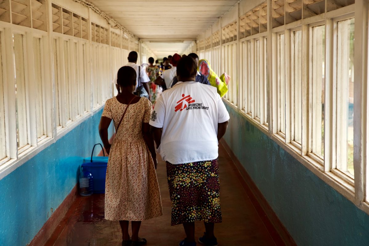 An MSF staff walks a patient along the corridors of Queen Elizabeth Central Hospital in Blantyre, Malawi