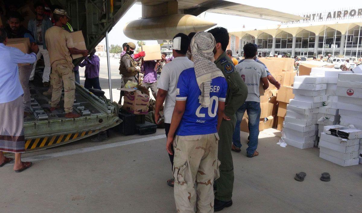 Yemeni workers unload boxes of relief aid from a Saudi military plane at Adens international airport in Yemens second city of Aden last year. (Getty Images)