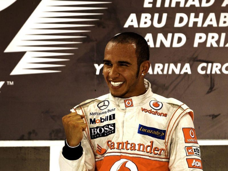 Lewis Hamilton of Great Britain and McLaren celebrates on the podium after winning the Abu Dhabi Formula One Grand Prix at the Yas Marina Circuit on November 13, 2011 in Abu Dhabi, United Arab Emirates. (Getty Images)