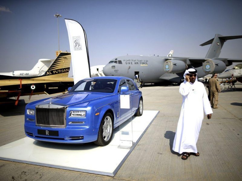 A businessman walks past a Rolls Royce motor car during the Dubai Airshow on November 18. (Getty Images)