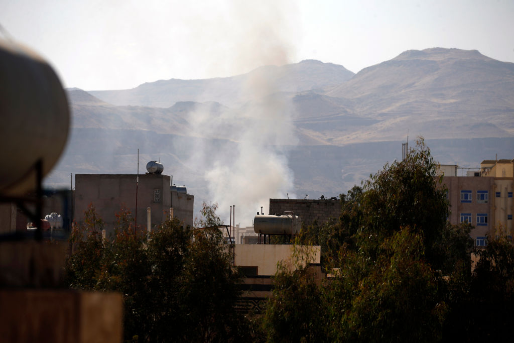 Smoke billows behind a building in the Yemeni capital Sanaa during clashes with supporters of Yemeni ex-president Ali Abdullah Saleh. 
 Photo: MOHAMMED HUWAIS/AFP/Getty Images.