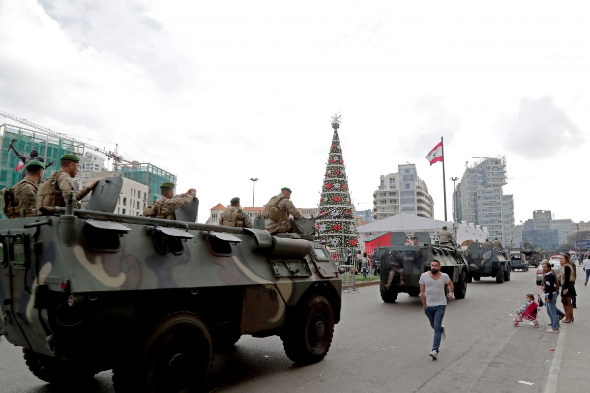 Lebanese soldiers stand guard the street as antigovernment protesters inspired by the French movement Yellow Vests Gilets jaunes demonstrate in Martyrs square in central Beirut on December 23 2018  Hundreds of Lebanese protested against deteriorating economic conditions as politicians are deadlocked over forming a new government Photo by A