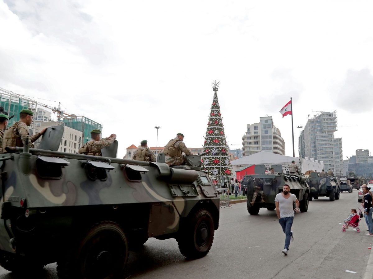 Lebanese soldiers stand guard the street as antigovernment protesters inspired by the French movement Yellow Vests Gilets jaunes demonstrate in Martyrs square in central Beirut on December 23 2018  Hundreds of Lebanese protested against deteriorating economic conditions as politicians are deadlocked over forming a new government Photo by A