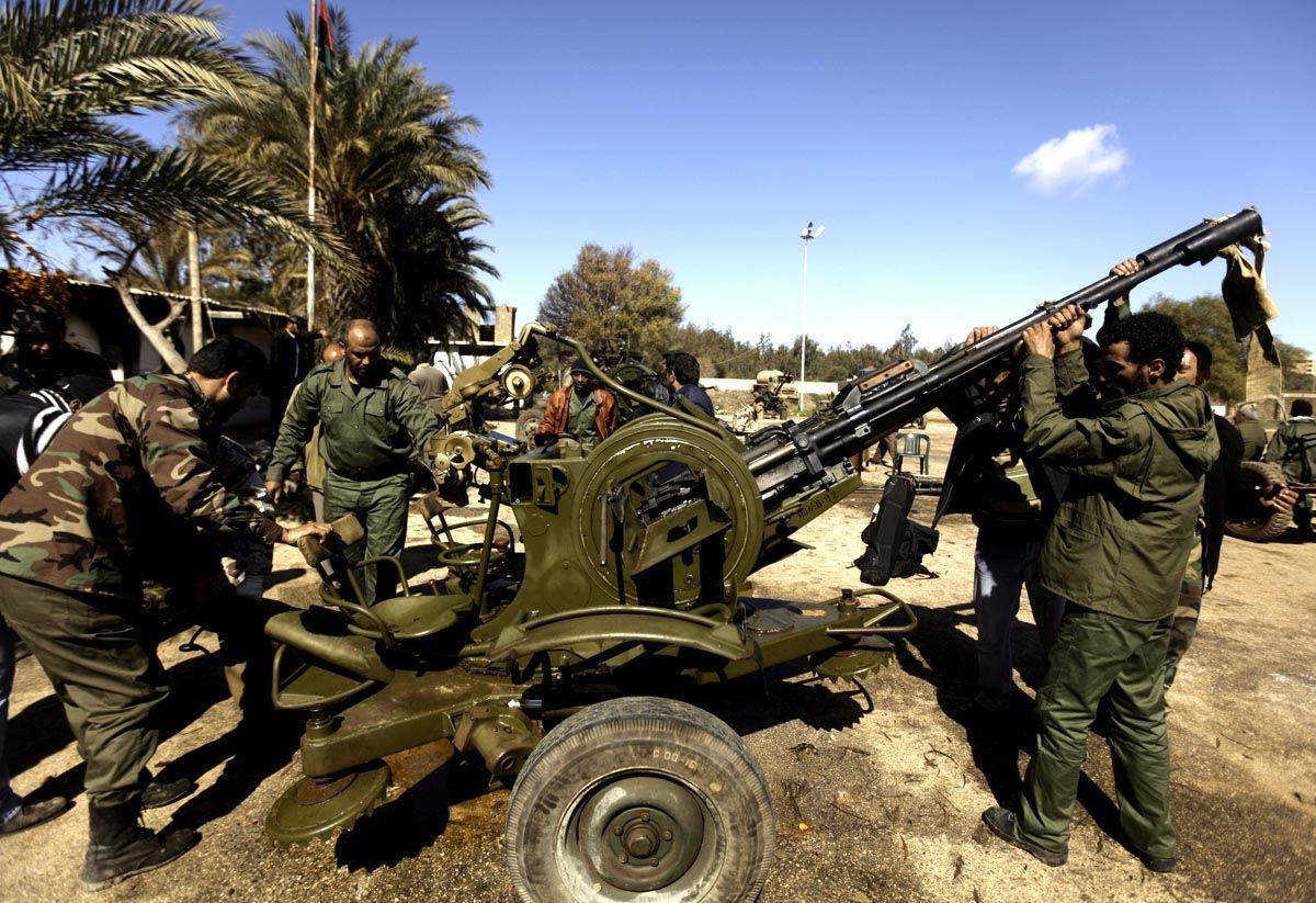 Libyan rebels deploy an anti-aircraft machinegun at a military base in the eastern city of Benghazi