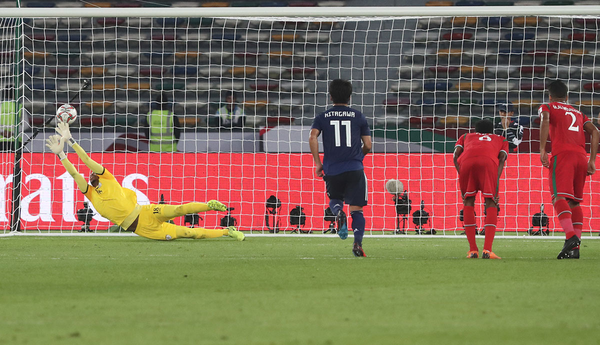 Oman's goalkeeper Faiz Al-Rushaidi fails to catch the ball as Japan's midfielder Genki Haraguchi (unseen) scores a penalty kick during the 2019 AFC Asian Cup group F football match between Oman and Japan at Hazza bin Zayed Stadium in Abu Dhabi on January 13, 2019.