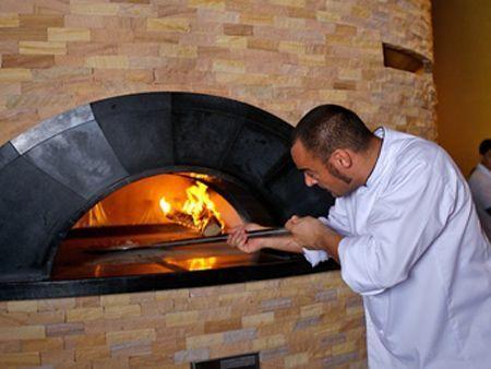 The family-style Italian trattoria, Ronda Locatelli, uses traditional stone pizza ovens