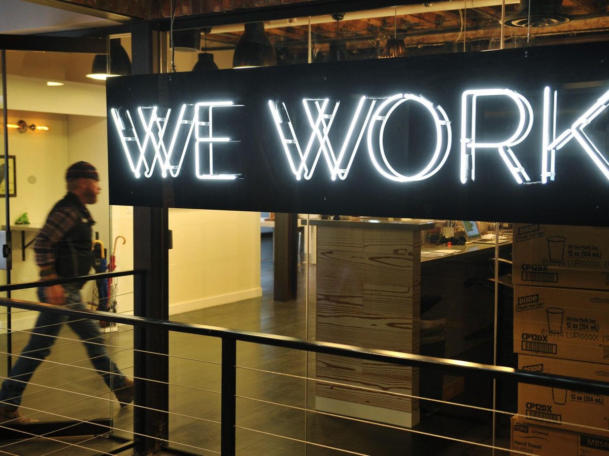 A man enter the doors of the WeWork cooperative coworking space in Washington DC In a large warehouse type office in Washington software coders work on apps while angel investors and mentors help budding entrepreneurs figure out strategy for their startups in what is being dubbed Silicon Valley on the Potomac.  Photo: MANDEL NGANAFPGetty I