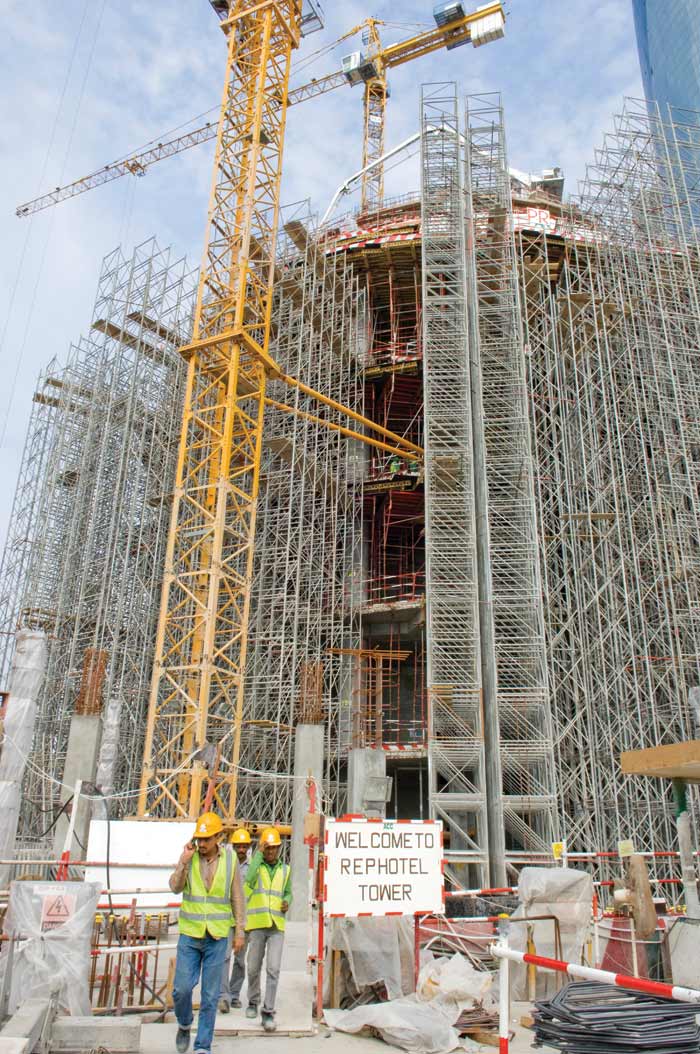 The structure so far , including a platform level, between the podium and tower, is still clamped in heavy-duty scaffolding