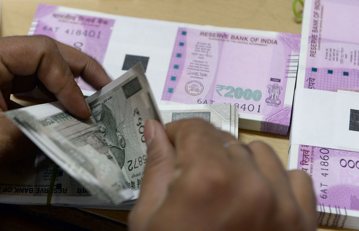 The rupee fell past the 74 to a dollar mark for the first time soon after the Reserve Bank of India's decision, and analysts, whose year-end estimates have been obliterated by the meltdown, cut their targets further.