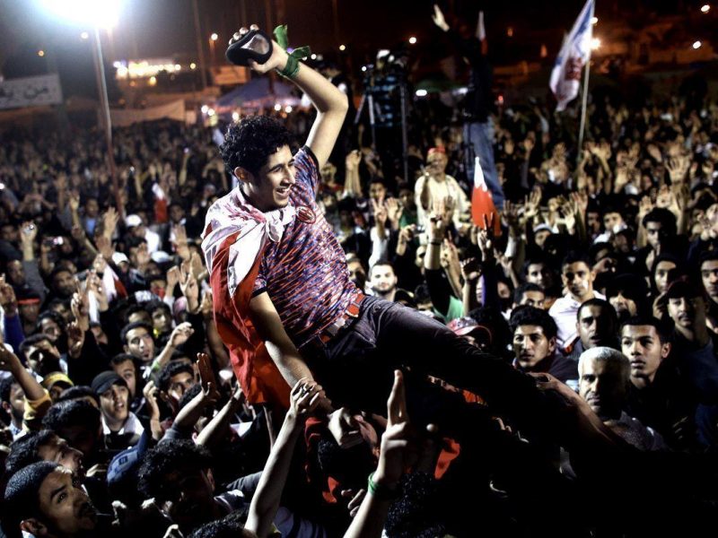 Anti-government protesters hoist a released political prisoner in the air in the Pearl roundabout (Getty Images)