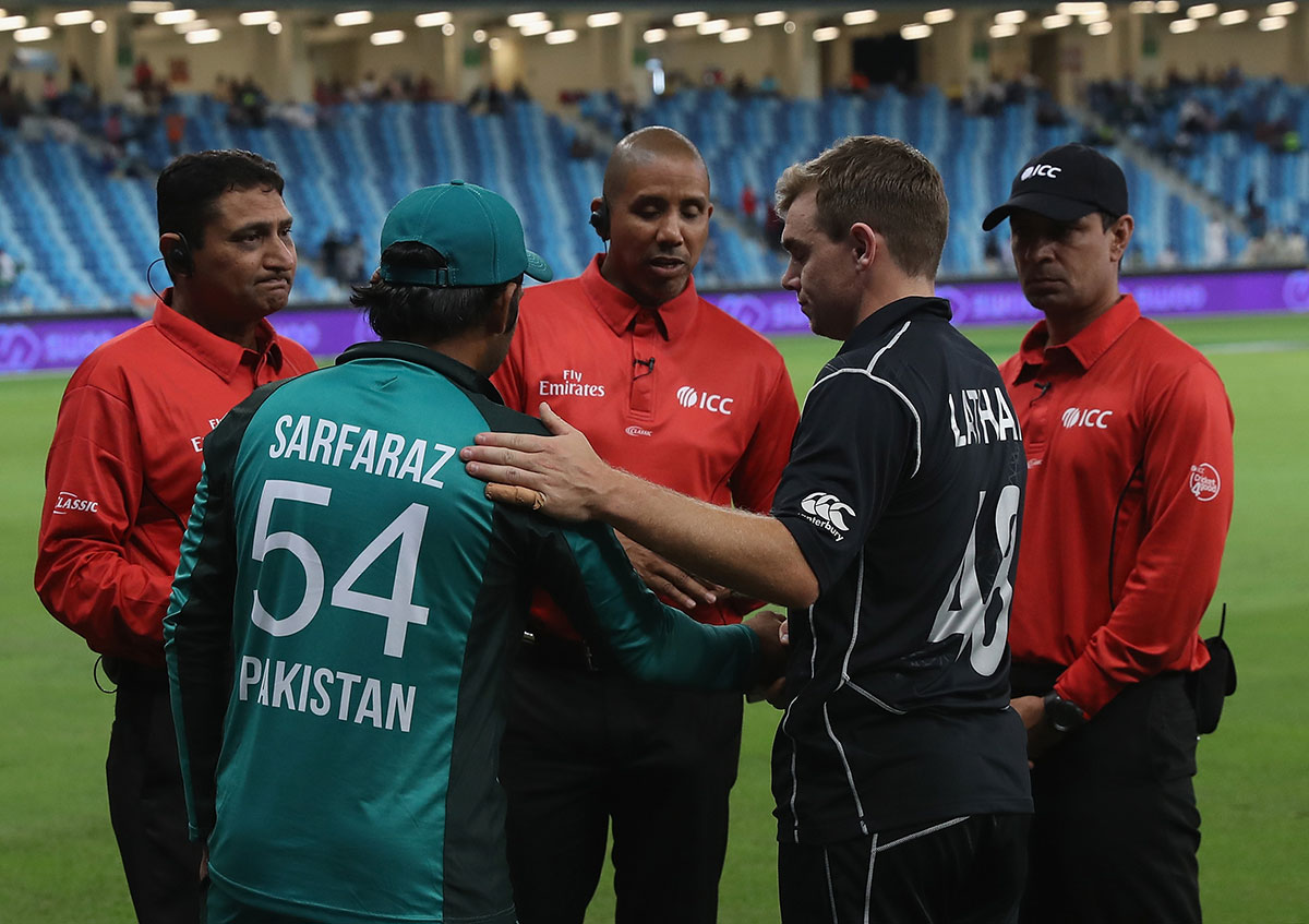 Tom Latham of New Zealand and Sarfraz Ahmed of Pakistan shake hands after play was called off due to heavy rain during the 3rd One Day International match between Pakistan and New Zealand at Dubai International Stadium on November 11, 2018 in Dubai.