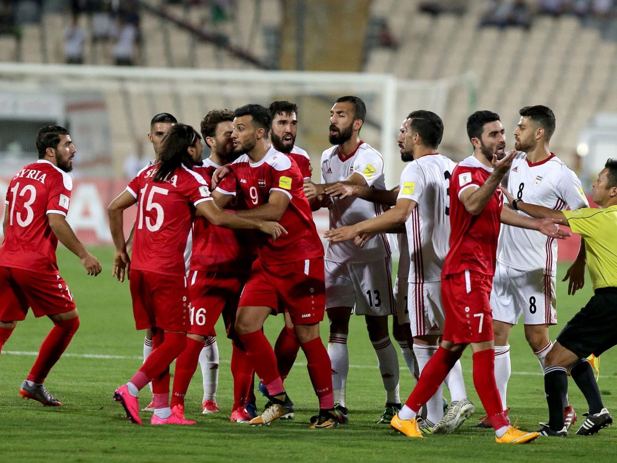 Players scuffle during the FIFA World Cup 2018 qualification football match between Iran and Syria at the Azadi Stadium in Tehran on September 5, 2017.